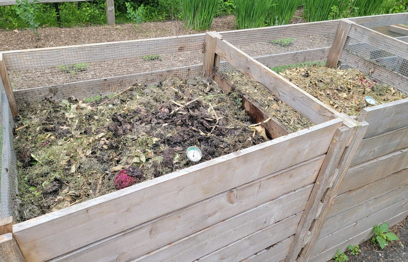 A couple of wooden boxes filled with dirt