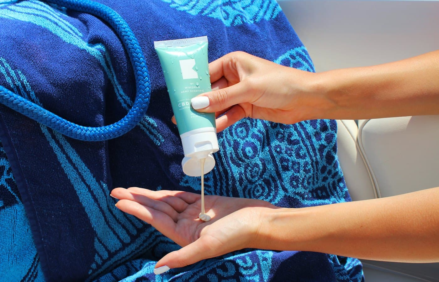 Person holding white plastic tube bottle