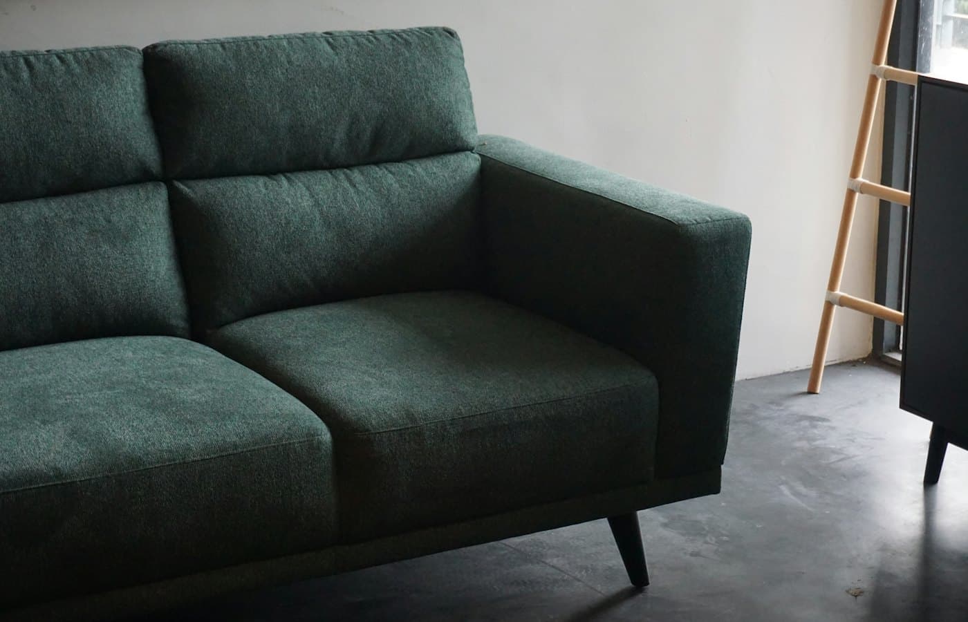 Gray cushion armchair beside white wall