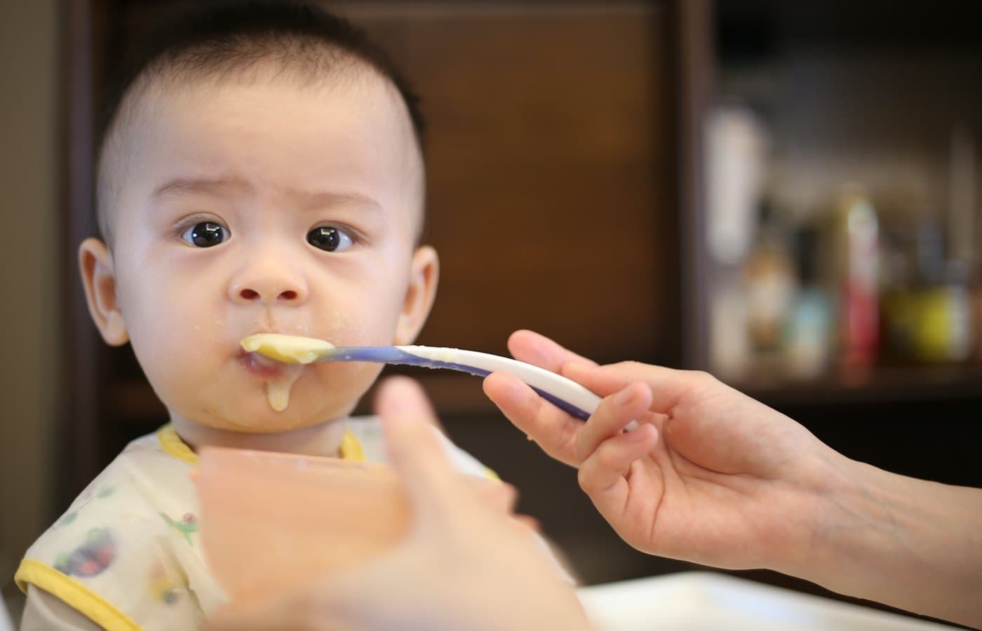 Person feeding baby