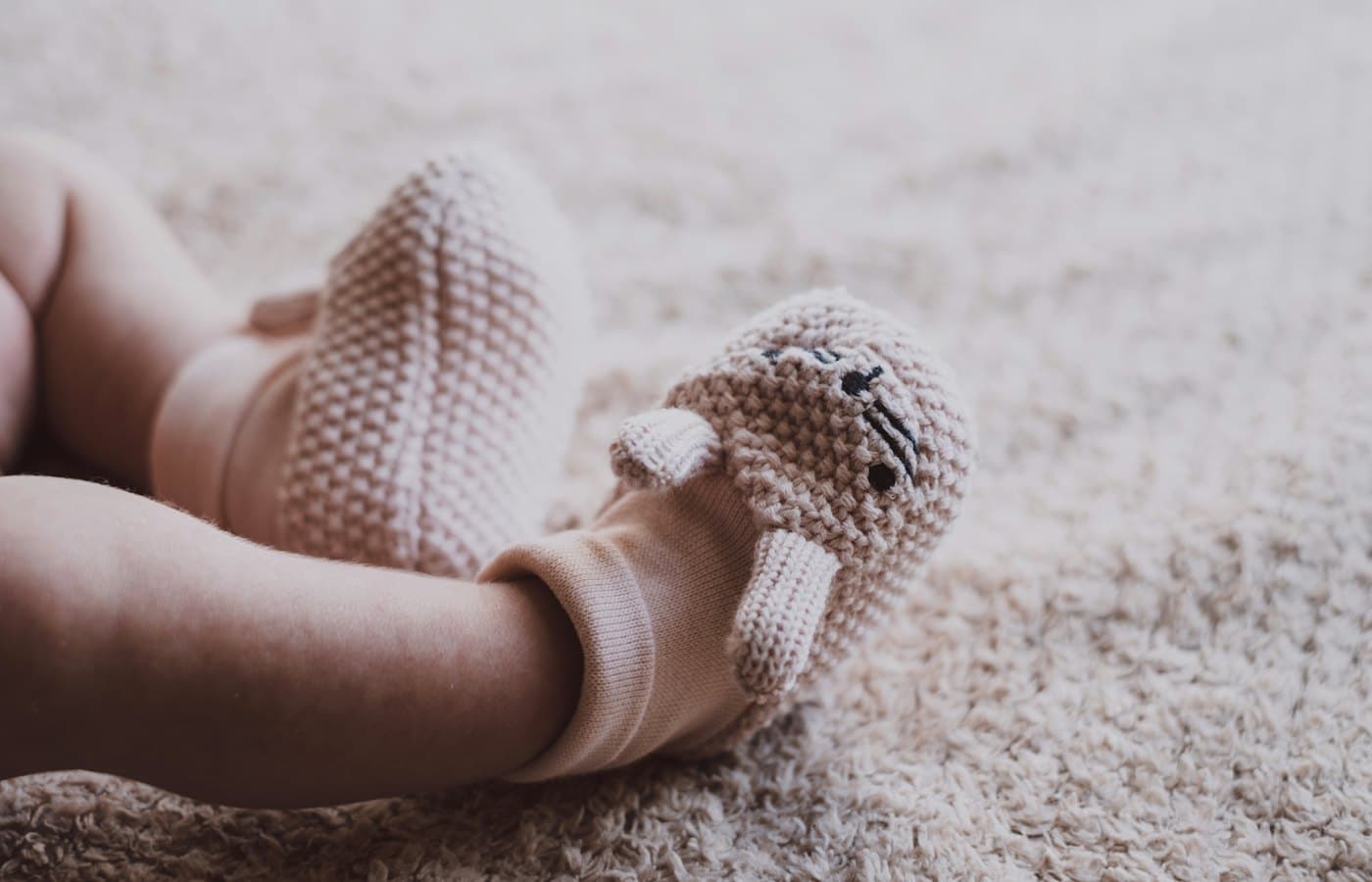 Baby in white knit shoes