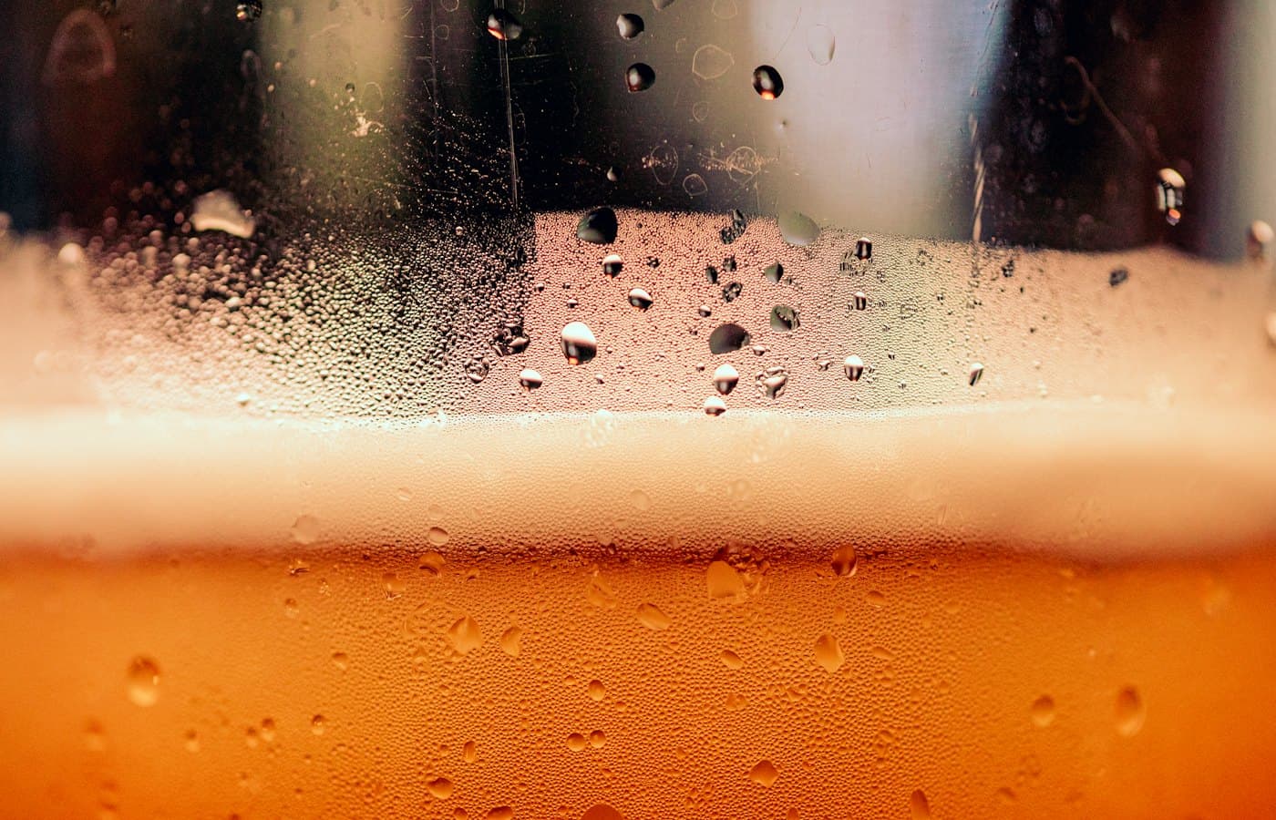 A close up of a glass of beer with drops of water