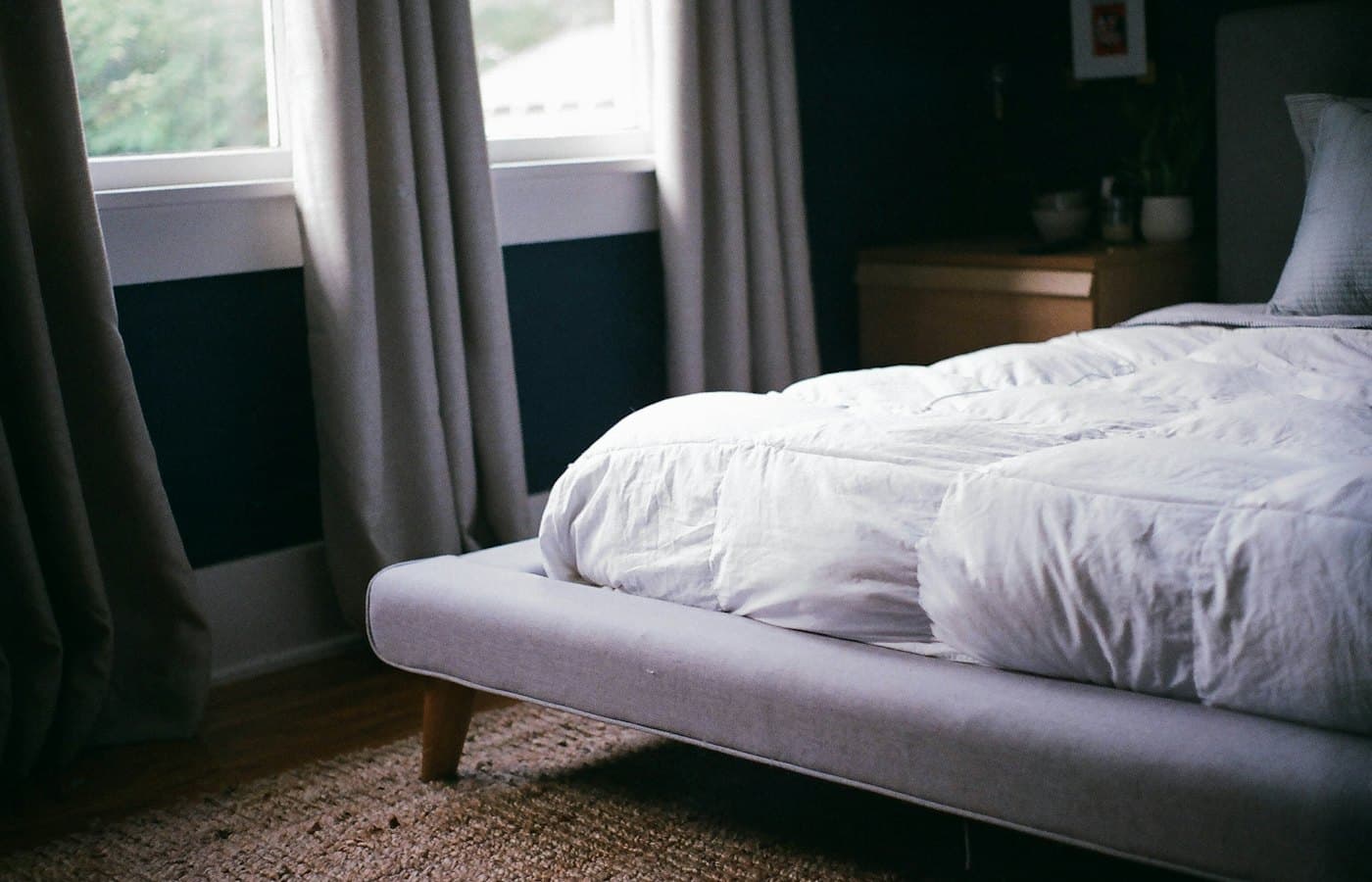 White bed by the window during daytime