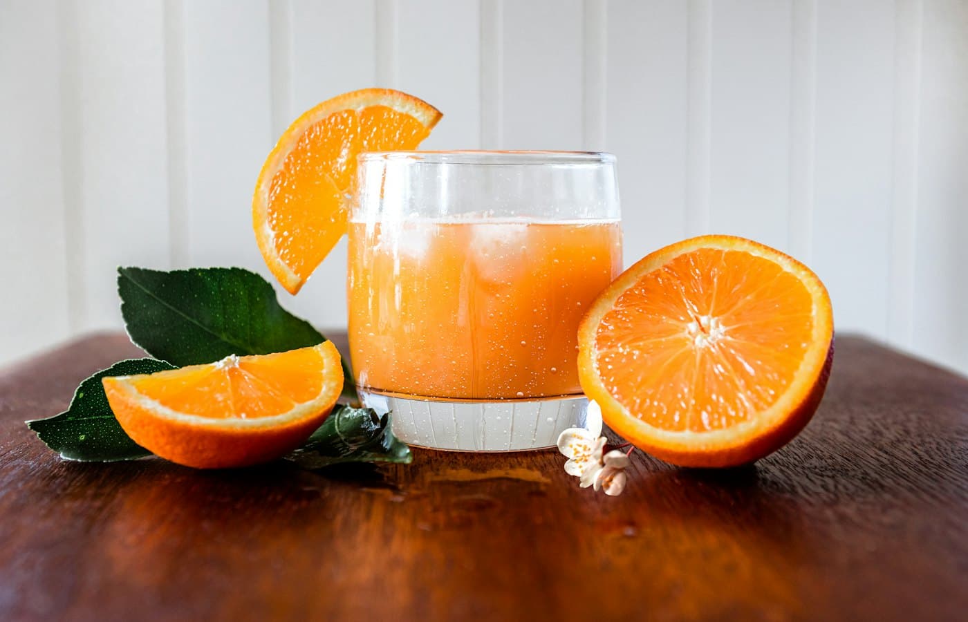 A glass of orange juice on a wooden table