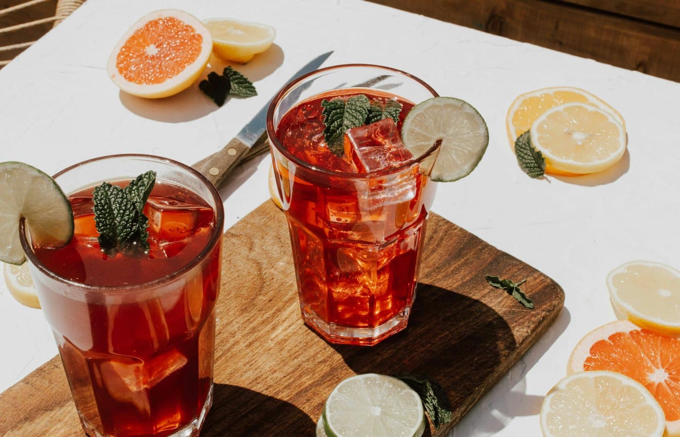 Two clear drinking glasses with filled red liquid