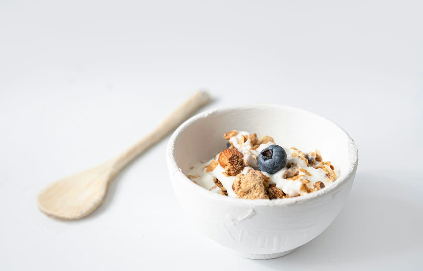 A bowl of cereal with a spoon on the side