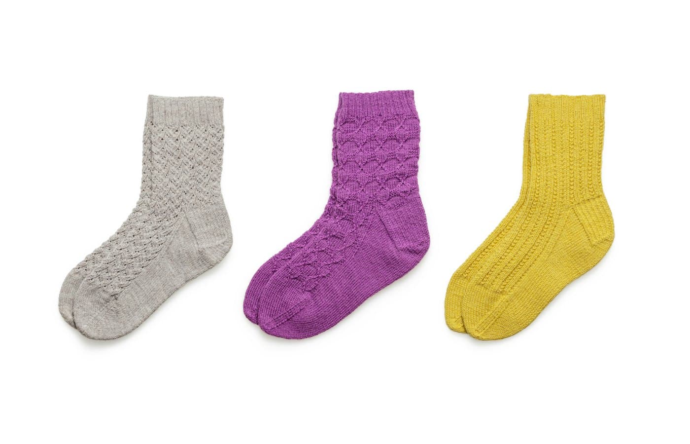 Blue and black socks on white background