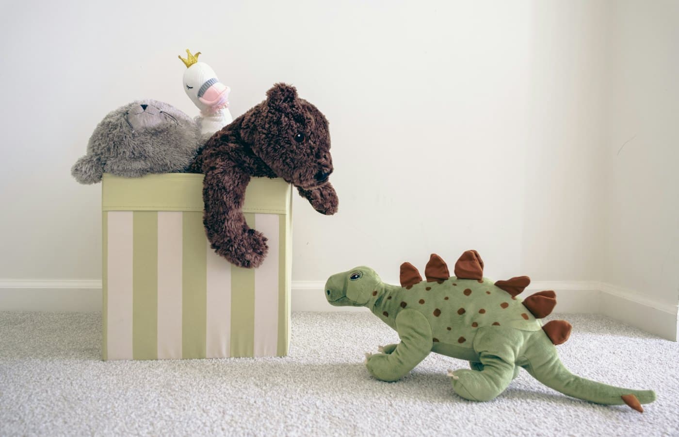 Two stuffed animals sitting on top of a box