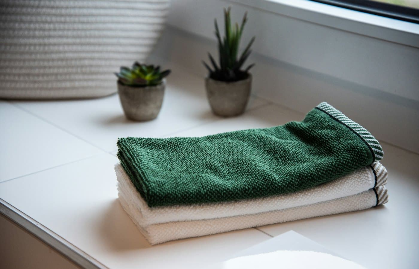 Folded towels near potted plants