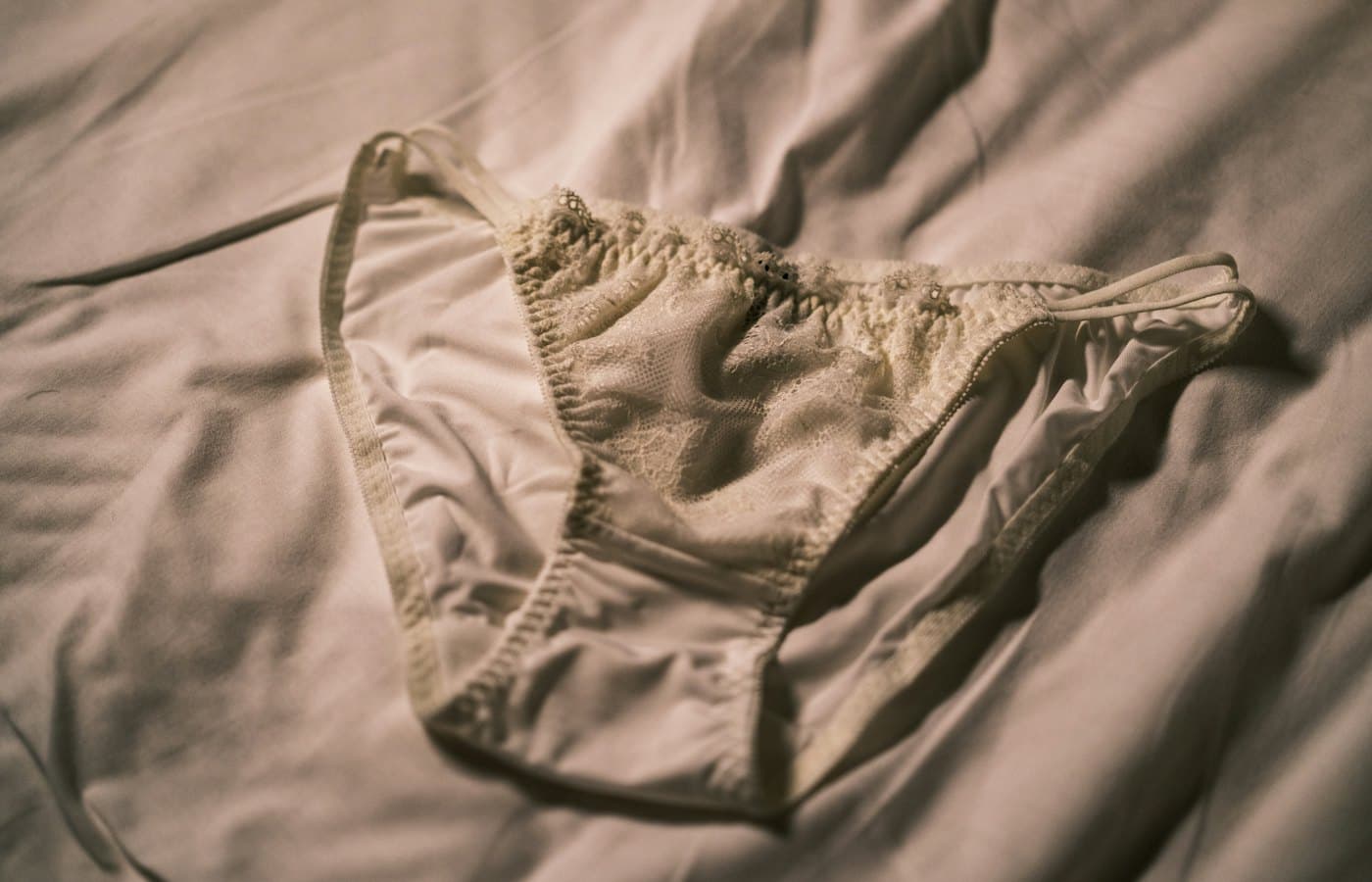 A bra that is laying on a bed