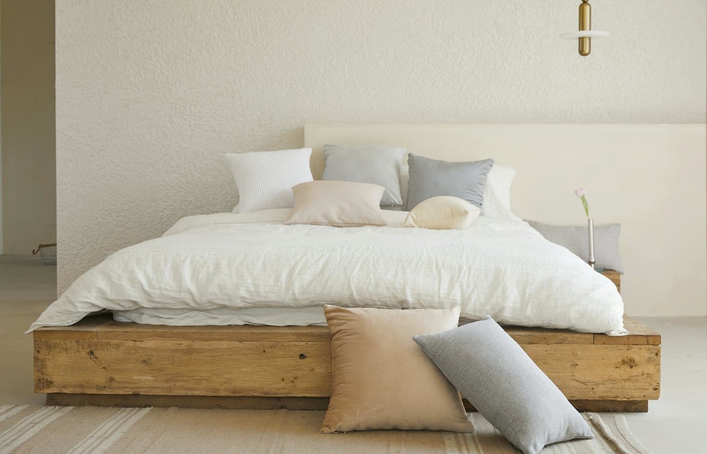 White bed pillow on brown wooden bed frame