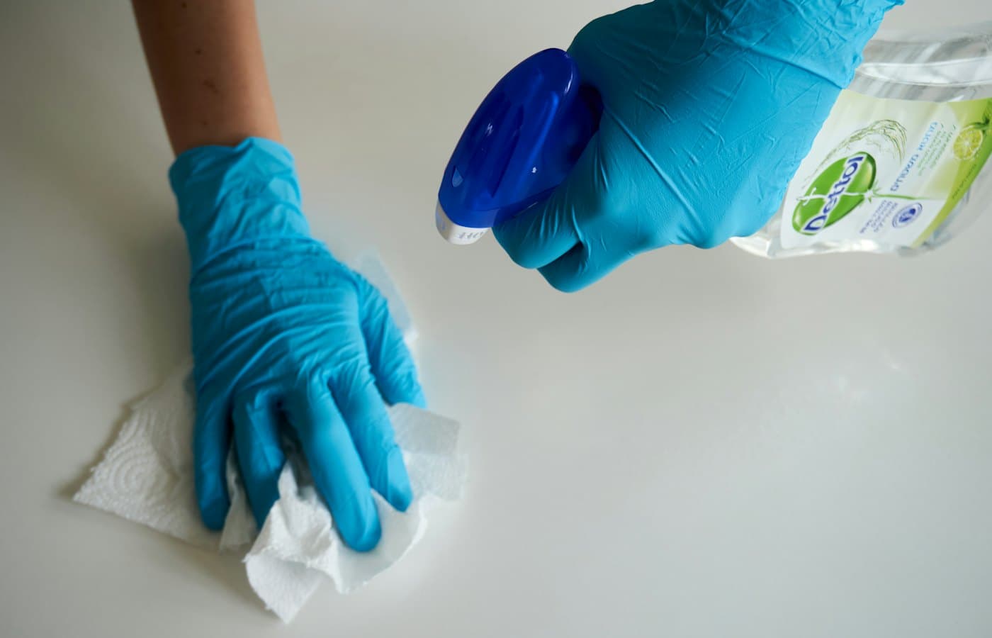 Person wiping surface with paper towel