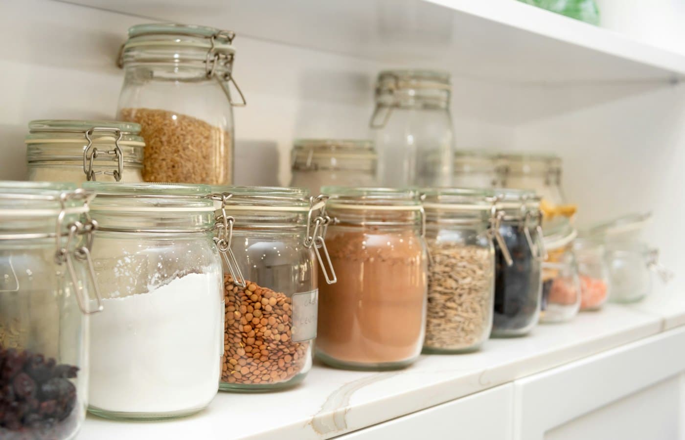 A row of jars filled with different types of food