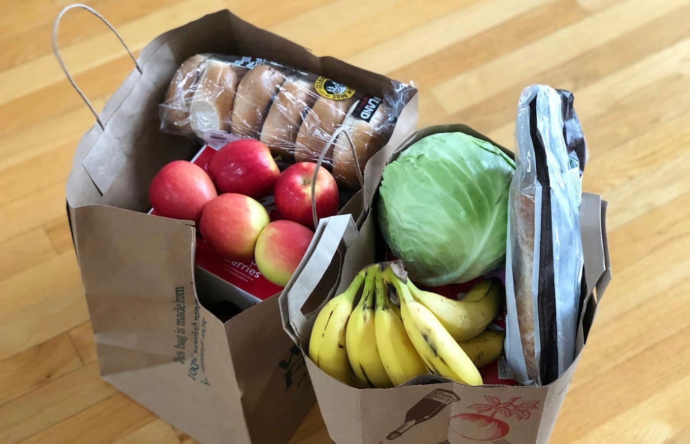 Apples and bananas in brown cardboard box